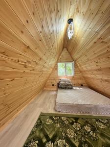 a room with a bed in a wooden cabin at A-Frame House Tosor in Tossor