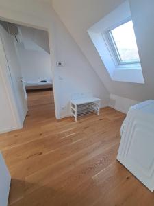 an attic room with a skylight and a wooden floor at Krems am Campus in Krems an der Donau