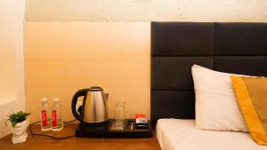 a coffee maker on a tray next to a bed at River Town Stays in Varanasi