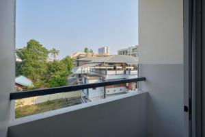 a balcony with a view of a building at North Centre in Cochin
