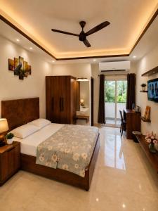 a bedroom with a bed and a ceiling fan at Pinto Eden Home Stay 5 Star Luxury Stay in Chikmagalur in Sangameswarpet