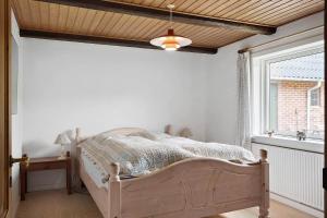 a bedroom with a bed in a room with a window at 591-Snedsted-Stenbjergvej-28 in Snedsted