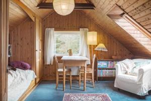 a bedroom with a table and a bed and a window at 591-Snedsted-Stenbjergvej-28 in Snedsted