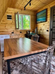 a dining room with a wooden table and chairs at A-Frame House Tosor in Tossor