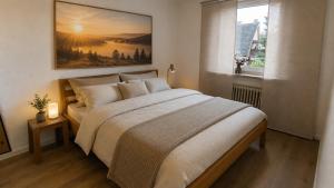 a bedroom with a bed and a painting on the wall at Living in Rheine in Rheine