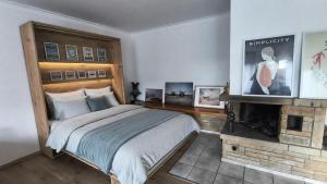 a bedroom with a large bed and a fireplace at Living in Rheine in Rheine