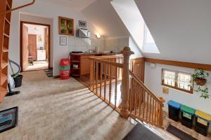 a room with a staircase and a kitchen with a sink at Apartamenty i Pokoje w centrum Karpacza in Karpacz