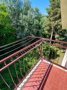 a walkway with a metal railing on top of it at Valleverde Apartment in Caraglio