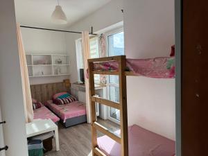 a small room with two bunk beds in it at Century hostel in Gdynia