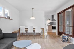 a white living room with a table and white chairs at 1102-Stege-Rylevej-24 in Stege