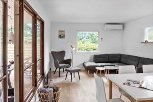 a living room with a couch and a table and chairs at 1102-Stege-Rylevej-24 in Stege