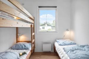 a bedroom with two bunk beds and a window at 1102-Stege-Rylevej-24 in Stege