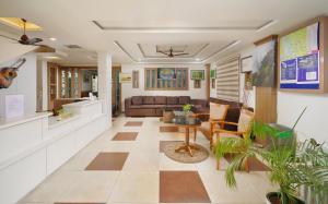 a living room with a couch and a table at North Centre in Cochin