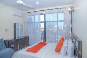 a bedroom with a bed and a large window at Andrew View Hotel in Dar es Salaam