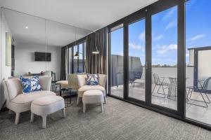 a living room with a view of a balcony at MainStay Suites Hawthorn in Hawthorn