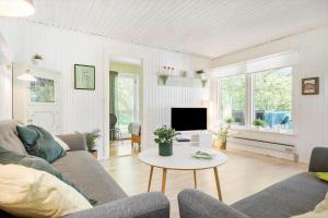 a living room with a couch and a table at 8229-Lundby-Stenurtvej-6 in Lundby