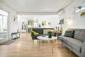 a living room with a couch and a table at 8229-Lundby-Stenurtvej-6 in Lundby