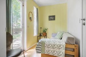 a small bedroom with a bed and a window at 8229-Lundby-Stenurtvej-6 in Lundby