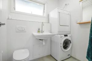 a white bathroom with a washing machine and a sink at 8229-Lundby-Stenurtvej-6 in Lundby +16 photos