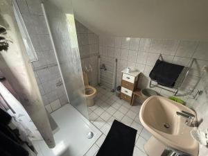 a small bathroom with a sink and a toilet at Chez KUD in Bourbon-Lancy