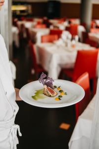 a plate of food on a table in a restaurant at Hotel Adlon in Lido di Jesolo