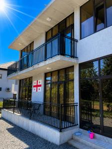 a building with a balcony on the side of it at LIFE GUARD ქობულეთი in Kobuleti