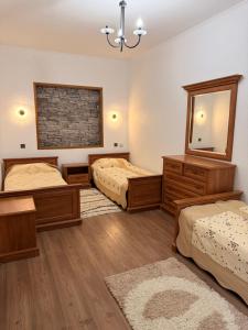 a bedroom with two beds and a mirror at Солнышко VIP 1 in Chok-Tal