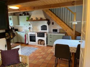 a kitchen with a bed and a staircase in a room at Mariehem Logi in Sjöbo