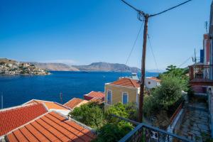 a view of the water and roofs of houses at Villa Pitini in Symi