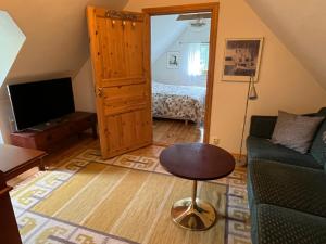 a living room with a couch and a table at Mariehem Logi in Sjöbo