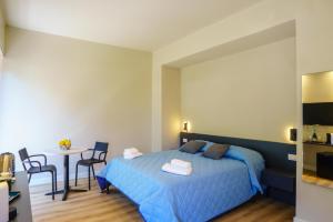 a bedroom with a blue bed and a table at Respiro di Mare in Riomaggiore