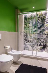 a green bathroom with a toilet and a shower at Respiro di Mare in Riomaggiore