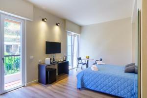 a bedroom with a bed and a desk and a television at Respiro di Mare in Riomaggiore +19 photos
