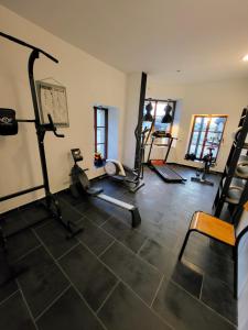 a gym with several treadmills and machines in a room at Aparthotel Des 2 Caps in Ambleteuse