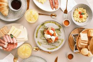 a table full of plates of food with breakfast foods at Olisa Al Mar in Maresias