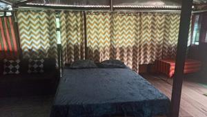 a bedroom with a bed in a room at The Hojai Farmland in Hāflong +3 photos