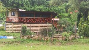 a house with a fence in front of it at The Hojai Farmland in Hāflong