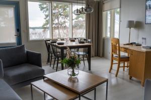 a living room with a couch and a table at Spa Hotel Kasnäs in Kasnäs