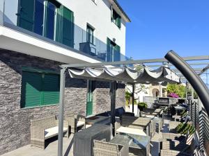 a patio with chairs and an umbrella at Paradise Villa Lopar in Lopar