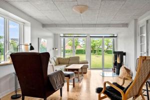 a living room with a couch and a table at 4231-Stege-Nymarksvej-21 in Stege +15 photos
