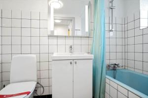 a bathroom with a toilet and a sink and a tub at 4231-Stege-Nymarksvej-21 in Stege