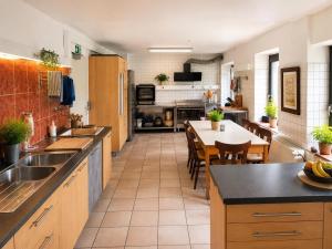 a large kitchen with a table and a dining room at Ferienhaus im Wiesengrund in Simmerath