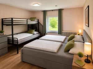 a bedroom with two beds and a bunk bed at Ferienhaus im Wiesengrund in Simmerath