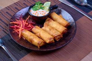 a plate of food with rolls and a dipping sauce at North Centre in Cochin