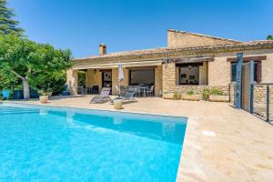 a swimming pool in front of a house at La Villa D'antan - Piscine in Nyons