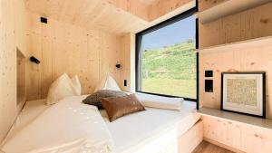 a bed in a small room with a window at Apartment Bergsee in Lunz am See