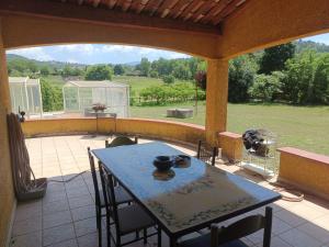 a table and chairs on a patio with a view at Divine Caravane in Digne-les-Bains
