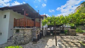 a house with a deck and a patio at Dermendzhiev Apartments Melnik in Melnik