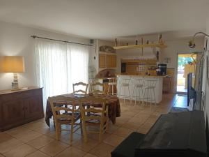 a kitchen and dining room with a table and chairs at Divine Caravane in Digne-les-Bains