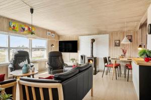 a living room with a couch and a fireplace at 1319-Thisted-Store-Knuds-Vej-9 in Thisted